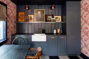 a kitchen with blue cabinets and a sink and a table at NP Boutique Lodge in Big Bear Lake