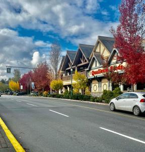 a car parked on the side of a road next to a building at Oceanside Manor - Ocean View in Qualicum Beach +12 photos