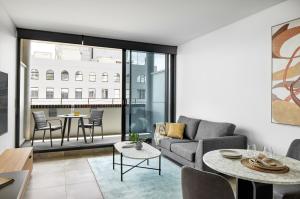 a living room with a couch and a table at Punthill Parramatta in Sydney