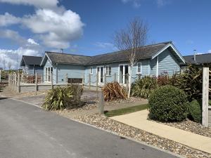 a blue house on the side of a road at Blue Bay at The Bay Filey, sleeps 4-6, 2 dogs welcome for free too in Filey