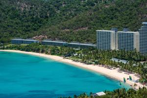 an aerial view of a beach and buildings at Frangipani Beachfront Lodge F5 on Hamilton Island by HamoRent in Hamilton Island