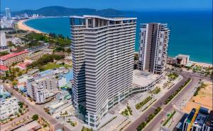 a tall building in a city next to a beach at Quy Nhon Pearl - FLC Sea Tower in Quy Nhon