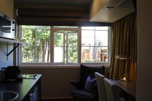 a room with a window with a chair and a desk at The Houston Wagga in Wagga Wagga