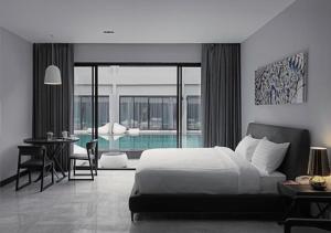 a bedroom with a bed and a swimming pool at S Ratchada Leisure Hotel - SHA PLUS in Bangkok