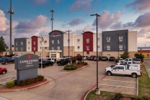 a parking lot at a car dealership with cars parked at Candlewood Suites Longview by IHG in Longview