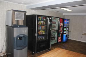 a room with two soda vending machines at Red Carpet Inn - Louisville in Louisville