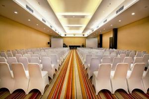 a large room with white chairs in it at Yasmin Hotel Karawaci in Tangerang