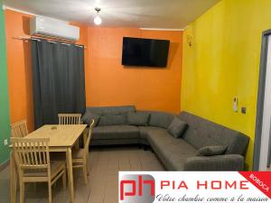 a living room with a couch and a table at PIA HOME La Pompe in Mamoudzou
