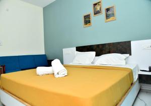 1 dormitorio con 1 cama grande y toallas. en Nilton Bay Residency, en Pondicherry