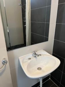 a white sink in a bathroom with a shower at Akara Perth in Perth
