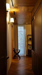 a hallway with a door to a room with a window at Bonum 1957 Hanok and Boutique in Seoul