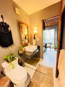 a bathroom with a toilet and a sink at Luz de Luna Tulum Villa in Tulum