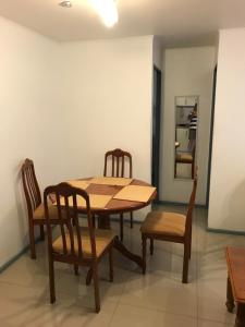 a dining room with a wooden table and chairs at Departamento La Serena in La Serena