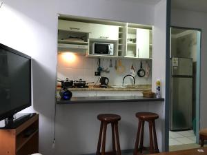 a kitchen with two stools in front of a counter at Departamento La Serena in La Serena