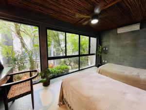 Ένα ή περισσότερα κρεβάτια σε δωμάτιο στο Luz de Luna Tulum Villa