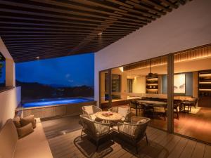 an open living room with a table and chairs at Ahn Lan Qiandaohu in Thousand Island Lake