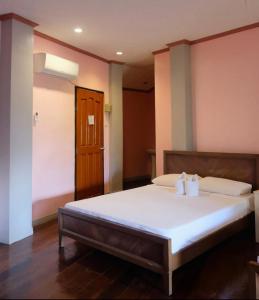 a bedroom with a large bed with two white pillows at Keyun’s Inn (Across Cloud 9) in General Luna
