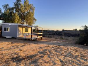 a tiny house sitting on top of a dirt field at Rejuvenation Cottage - Wine Country Tranquility in Temecula +11 photos