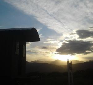 a view of the sunset from a house with a fence at Tren Del Desierto in Villa Unión
