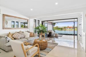 a living room with a couch and a table at Elite Holiday Homes Coobowie Waters in Gold Coast