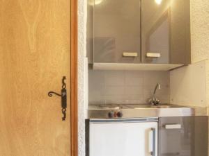 a small kitchen with a sink and a cabinet at Studio à Serre-Chevalier avec Parking, Wifi et Local à Ski - FR-1-330E-65 in Serre Chevalier +10 photos