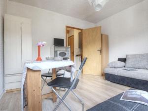 a small living room with a table and a couch at Studio à Serre-Chevalier avec Parking, Wifi et Local à Ski - FR-1-330E-65 in Serre Chevalier