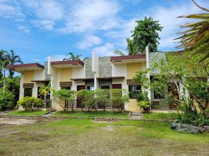 a house with a garden in front of it at La Belle Staycation in Puerto Princesa City