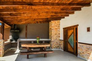 a patio with a wooden table and a wooden ceiling at Lucero in Mazamitla