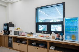 a kitchen with a counter with food on it at Browndot Hotel Mokpo Gotbawi in Mokpo