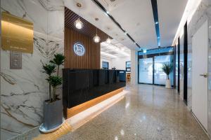 an office lobby with a hallway with potted plants at Browndot Hotel Mokpo Gotbawi in Mokpo +47 photos