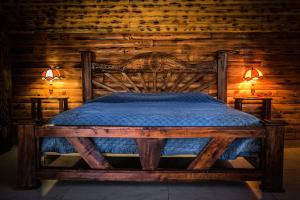a wooden bedroom with a bed with a wooden wall at Lucero in Mazamitla