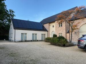 a house with solar panels on the side of it at Cosy Studio met Zwembad in Beringen