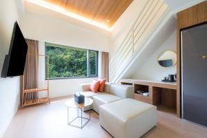 a living room with a white couch and a window at Browndot Hotel Mokpo Gotbawi in Mokpo