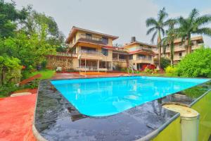 a swimming pool in front of a house at Velvet Rooms By 29bungalow in Lonavala