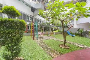 a playground in the yard of a building at RedLiving Apartemen Margonda Residence 2 - Tower 2 in Pondokcina