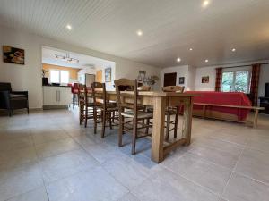 a kitchen and dining room with a table and chairs at Grande Maison Familiale avec SPA, Plage à Proximité, Jardin et Parking - 10 Couchages - FR-1-246A-153 in Grand-Village-Plage