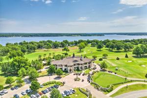 an aerial view of a mansion with a golf course and a lake at Balcony & Lake View: Modern Condo in Monkey Island in Monkey Island