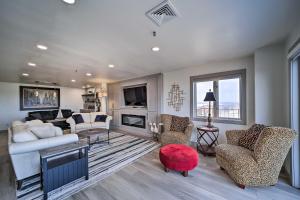 a living room with a white couch and chairs at Balcony & Lake View: Modern Condo in Monkey Island in Monkey Island