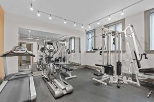 a gym with treadmills and machines in a room at Cozy St Louis Apartment Less Than 4 Mi to Downtown! in Tower Grove