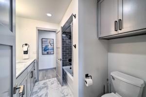 a bathroom with a toilet and a sink at Balcony & Lake View: Modern Condo in Monkey Island in Monkey Island +18 photos