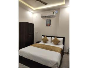 a bedroom with a bed with white sheets and pillows at Royal Galaxy, Narnaul in Nārnaul