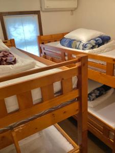 a group of bunk beds in a room at IZA Kamakura Guest House and Bar in Kamakura
