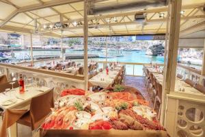 a restaurant with a bunch of seafood on tables at Xlendi Central Apartment in Xlendi