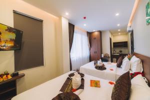 Postel nebo postele na pokoji v ubytování GREENECO DA LAT HOTEL - Khách sạn Green Eco Đà Lạt