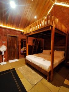 a bedroom with a bunk bed and a bathroom at Holygram Krushi Paryatan in Panchgani