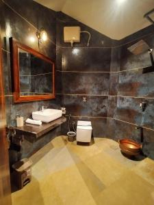 a bathroom with a sink and a toilet at Holygram Krushi Paryatan in Panchgani