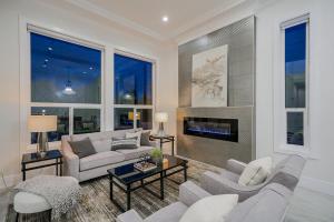 a living room with white furniture and a fireplace at Sun suite in Surrey