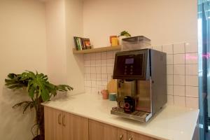 a kitchen with a microwave on top of a counter at Olive Richmond Circle - By Embassy Group in Bangalore