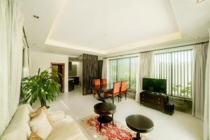 a living room with a couch and a table at The Ocean Villas Managed by The Ocean Resort in Danang