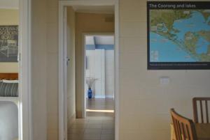 a hallway leading to a room with a map on the wall at Hideaway Tom’s on Mundoo Channel - Waterfront in Hindmarsh Island